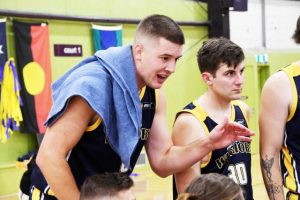 Youth carry the Warriors flag