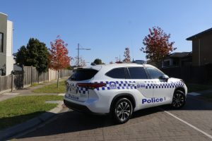 Police block street and arrest man in Officer