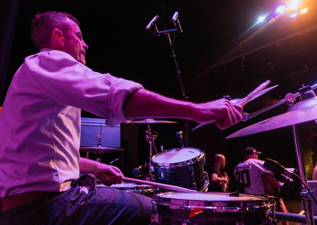 Principal hits the drums for charity